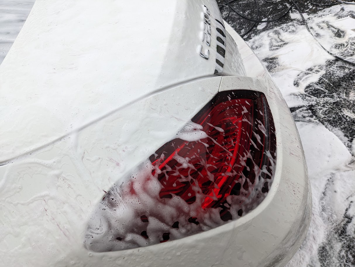 Purple iron fallout reaction visible on white vehicle paint